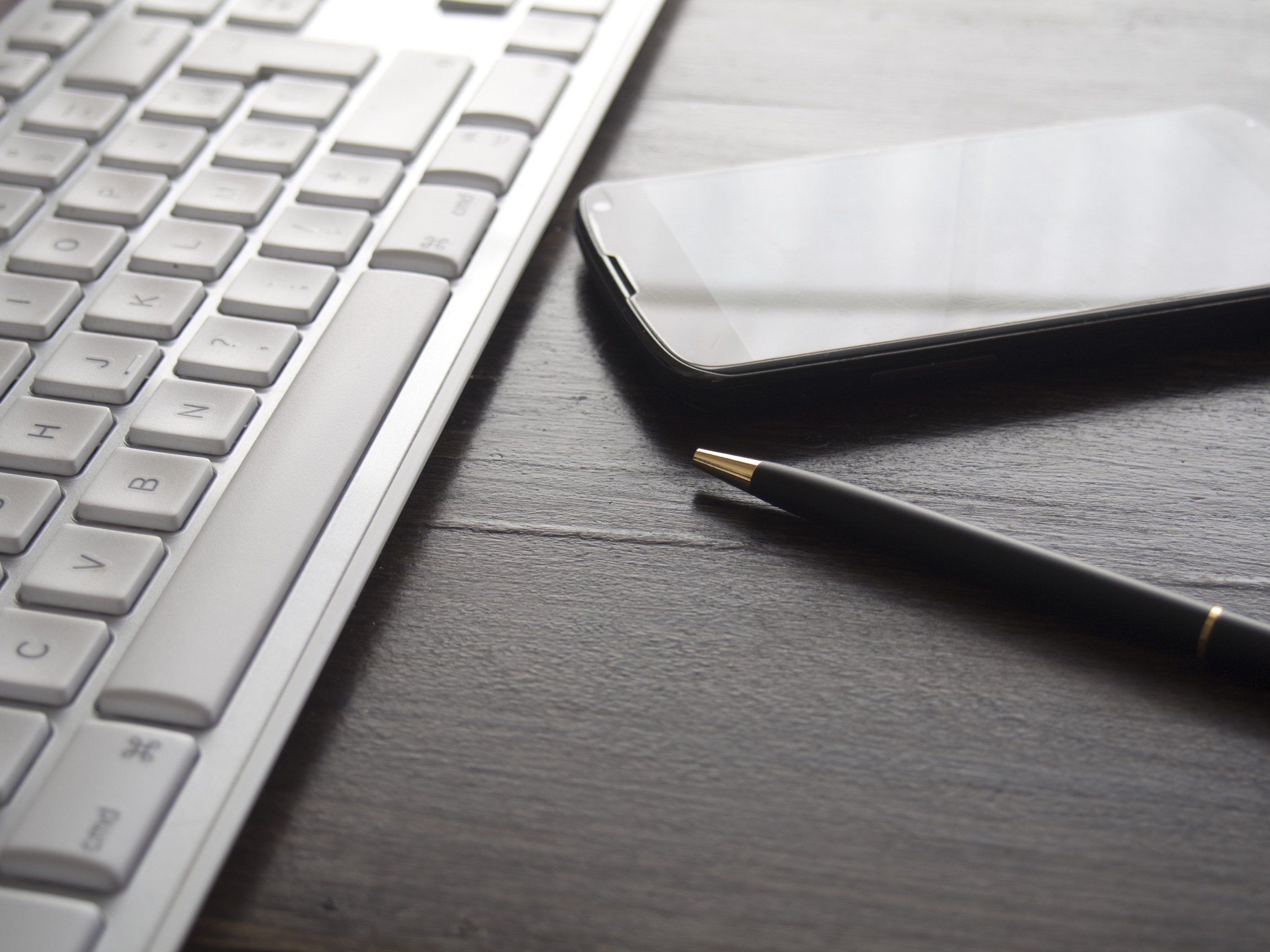 Desk with Gadgets and a Pen